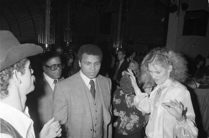 Former heavyweight boxing champion Muhammad Ali maintains a neutral expression as he makes his way across Studio 54